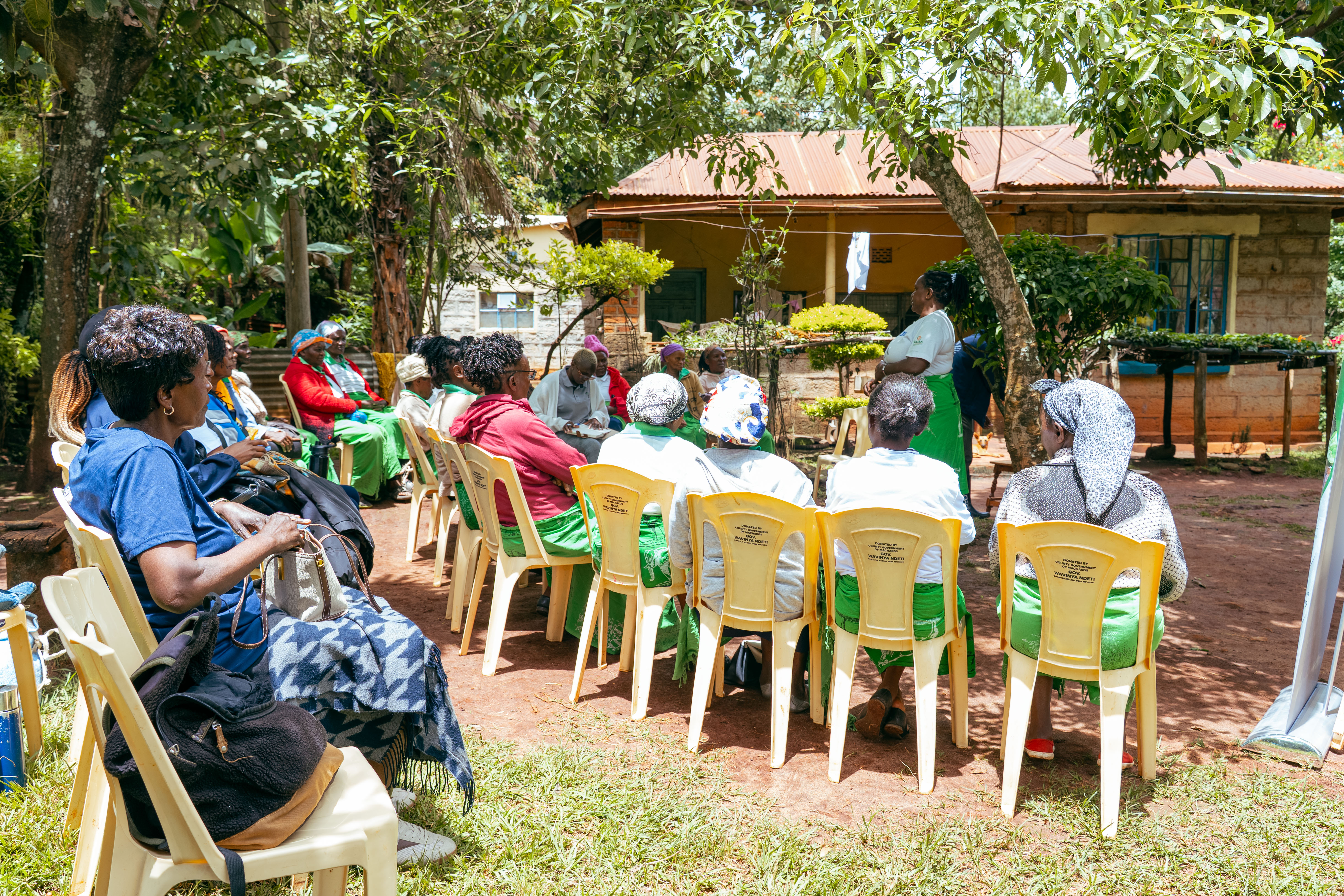 Donate page hero — authentic community imagery showing farmers, women leaders, youth engagement and agroecological activities in grassroots settings with dim atmospheric natural lighting and deep shadows