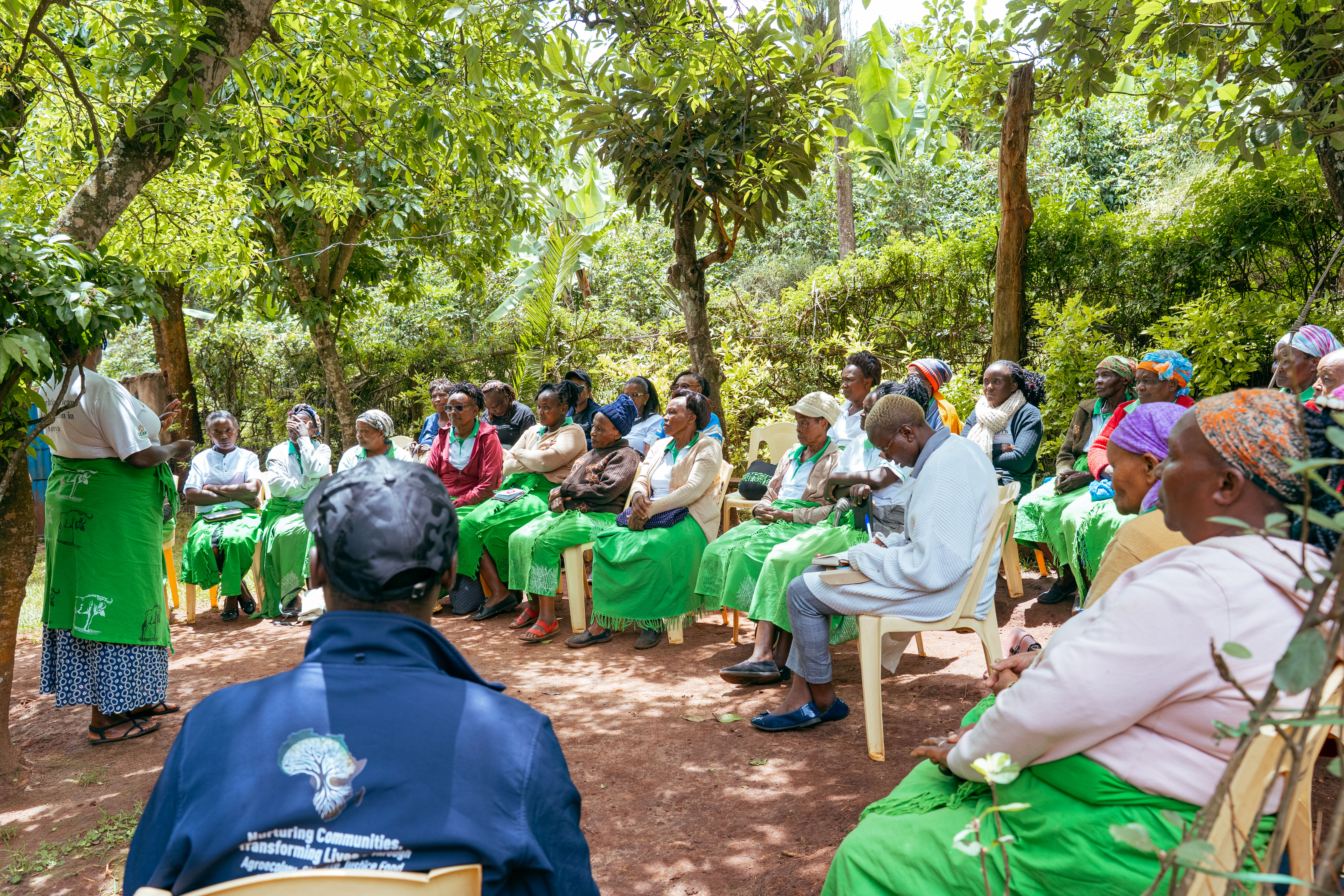 Warm, hopeful community imagery — farmers and community members building sustainable futures together