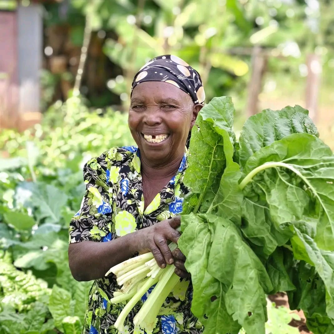 Women farmers working together on a hillside farm plot